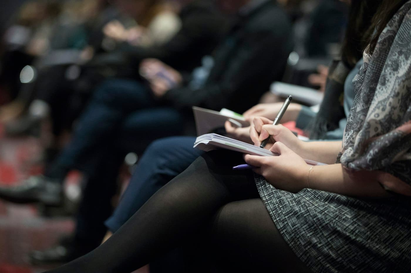 Attendee taking notes during a session