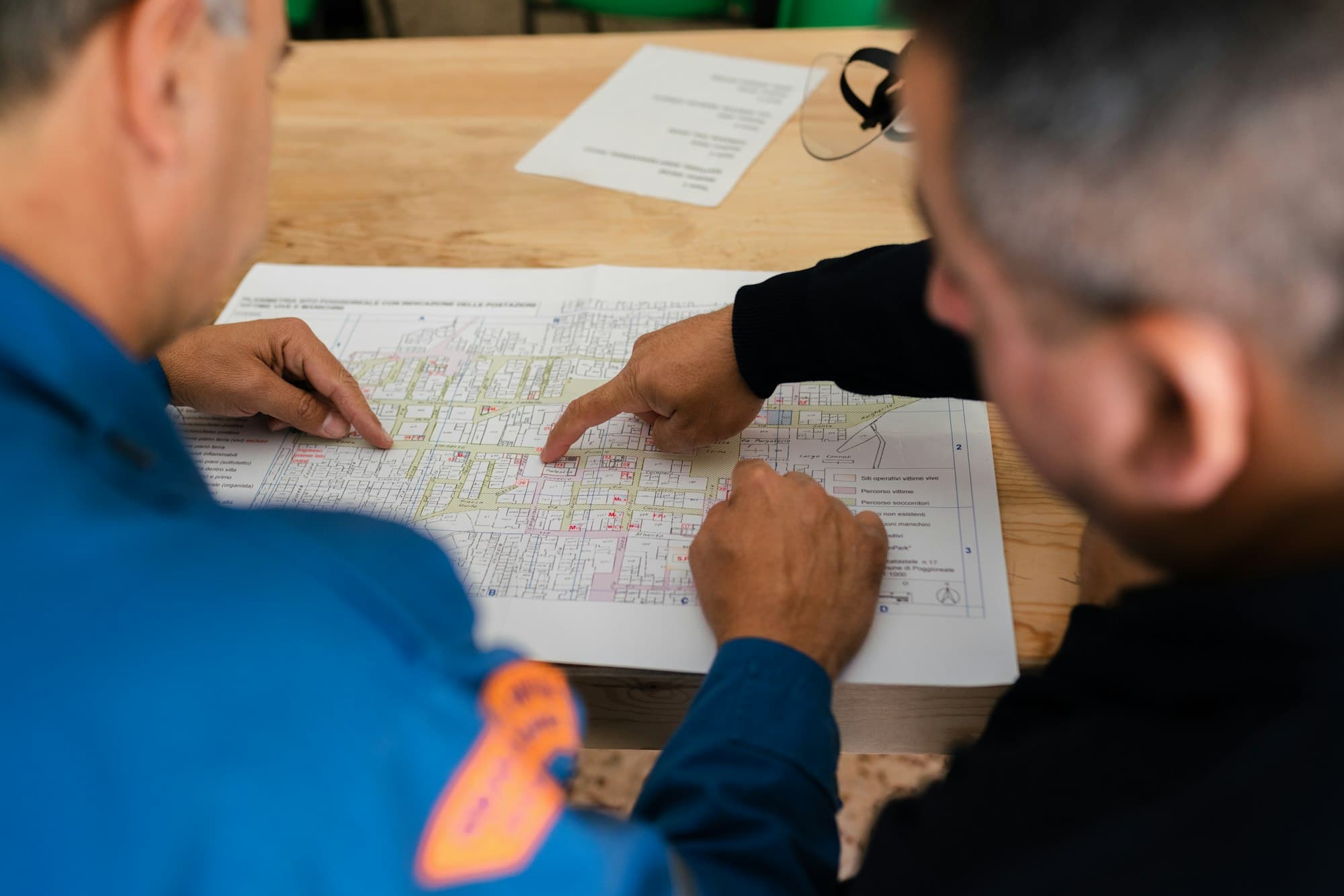 Two engineers reviewing a technical drawing